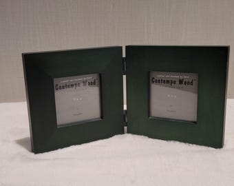 May include: A dark green, hinged double photo frame. Each square frame is 3x3 inches and has the text "Contempo Wood Collection" printed on it.
