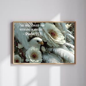 Puede incluir: Impresión enmarcada con un águila blanca, flores blancas y plumas. El texto "HE WILL COVER YOU WITH HIS FEATHERS" - Salmo 91:4 se muestra en blanco. La obra de arte tiene una calidad suave y etérea, con un marco de madera.