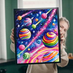 May include: A watercolor painting of a galaxy with colorful planets and stars. The planets are striped with rainbow colors and have rings around them. The background is a dark blue with pink and purple streaks.