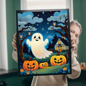 May include: A framed Halloween-themed art print featuring a friendly ghost, jack-o'-lanterns, a house, and owls under a starry night sky. The artwork is in a cartoon style with vibrant colors, perfect for seasonal decor.