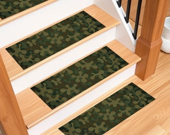 May include: Four green and brown camouflage patterned stair treads for a wooden staircase.