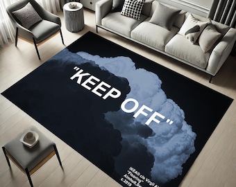 May include: A black and blue rug with a white cloud design and the text "KEEP OFF" in white. The rug also includes the text "IKEA® c/o Virgil Abloh™" "Flooring" Almhult, Sweden c.2019.