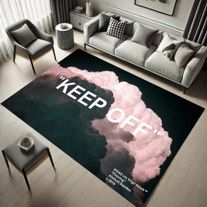 May include: A black and pink rug with a white cloud design and the text "KEEP OFF" printed on it. The rug also includes the text "IKEA® c/o Virgil Abloh™" and "Flooring" in white.