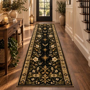 May include: A long rectangular runner rug featuring a black background with a repeating pattern of gold celestial stars, crescent moons, and white floral motifs. The rug has a decorative border with a repeating geometric and leaf-like design.