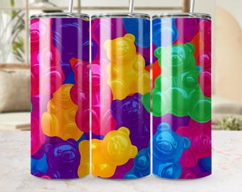 May include: Three stainless steel tumblers with a colorful gummy bear pattern. The tumblers are filled with gummy bears in various colors, including purple, pink, yellow, green, and blue.