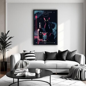 May include: A framed art print featuring a black cat, a bottle, and a cocktail glass. The artwork has a dark background with the Eiffel Tower and text that reads "LE CHAT NOIR FRENCH LIQUEUR". The print is displayed above a gray sofa.