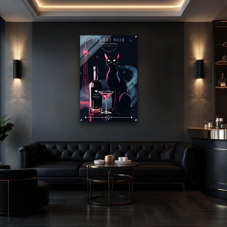 May include: A framed art print featuring a black cat, a bottle, and a martini glass. The print has a dark blue background with the Eiffel Tower in pink. The text "LE CHAT NOIR FRENCH LIQUEUR" is at the top.