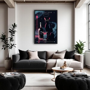May include: A framed art print featuring a black cat, a bottle, and a cocktail glass. The print has a dark background with the Eiffel Tower in the distance. The text "LE CHAT NOIR FRENCH LIQUEUR" is at the top.