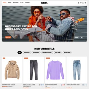 May include: Website homepage featuring a shopping cart with two people wearing sunglasses. The text "NECESSARY ATTIRE FOR GIRLS AND BOYS" is displayed. Below are product images: a tan hooded jacket, black jeans, a purple long-sleeve tee, and light blue denim pants.