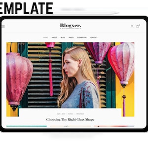 May include: A digital tablet displays a website template with the text "Blogxer." The website features a photo of a woman with pink lanterns in the background. The text "Choosing The Right Glass Shape" is visible.