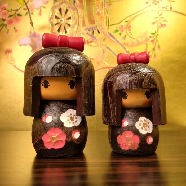 Vintage Kokeshi Doll Set: Hand-Painted Plum Blossom Design, Dark Wood