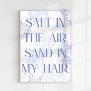 May include: A white background with a blue seashell pattern and the text "Salt in the air. Sand in my hair." in blue.