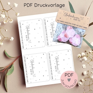 May include: Printable PDF template for gift tags with the text "Glücksschweine in der Tüte" (Lucky Pigs in the Bag) and "Für einen sauguten Start ins neue Jahr!" (For a great start into the new year!). The tags are decorated with small snowflakes and a pig illustration.
