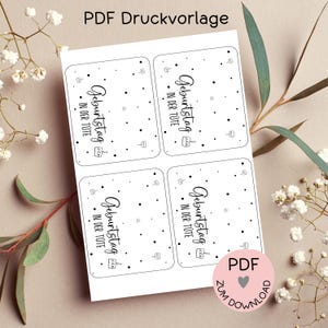 May include: Four printable gift tags with black and white polka dots and the text "Geburtstag in der Tüte" which translates to "Birthday in the bag". The tags are designed for a birthday gift.