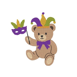 May include: A brown teddy bear wearing a purple bow tie and a jester hat with purple, yellow, and green accents. The bear holds a purple mask with a green and yellow feather design on a stick. The image is on a white background.