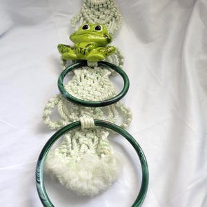 May include: A handmade wooden sign with the text "Welcome to our home" in a handwritten style. The sign is painted white with black lettering and a distressed finish, perfect for home decor.