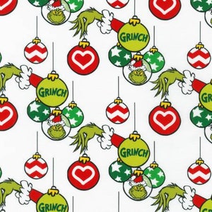 May include: A white background with a repeating pattern of green Grinch hands reaching for Christmas ornaments. The ornaments are red, green, and white with a variety of designs, including hearts, stars, and stripes. The text "Grinch" appears on some of the ornaments.