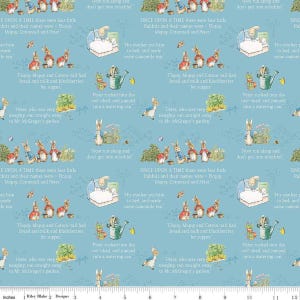 May include: Blue fabric featuring illustrations from a children's storybook. The design includes rabbits, text excerpts, and scenes with beds, watering cans, and gardens. The fabric is suitable for quilting and crafting.