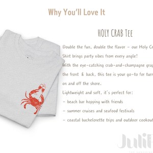 May include: Light gray Holy Crab Tee with a red crab and champagne glass graphic. The text on the shirt says "Holy Crab Tee". The shirt is lightweight and soft.