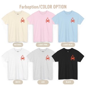 May include: Six short-sleeved t-shirts in various colors: natural, light pink, light blue, white, ash, and black. Each shirt features a small red crab graphic. The text "Farboption/COLOR OPTION" is at the top.