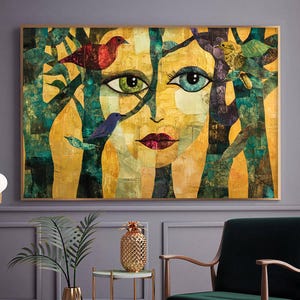 May include: A framed artwork depicting a stylized face with green and blue eyes, red lips, and birds on tree branches. The artwork uses a yellow and green colour scheme, with a gold frame.