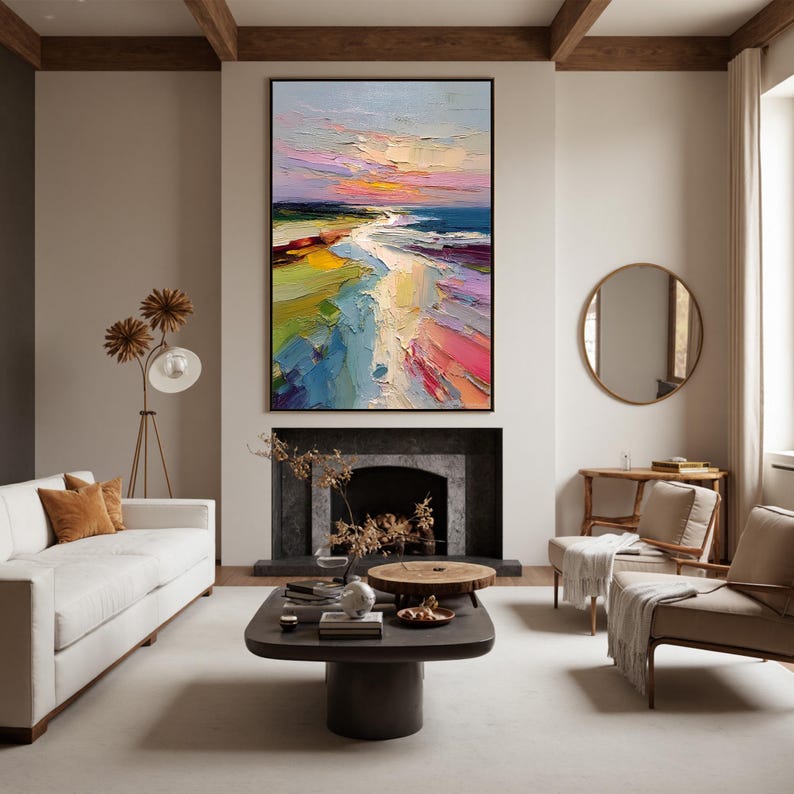 May include: A large, rectangular abstract painting with a black frame. The artwork depicts a colorful beach scene with a vibrant sunset. The painting features bold brushstrokes and a palette of blues, pinks, yellows, and greens, creating a textured and dynamic visual experience.