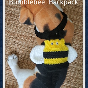 May include: A stuffed animal wearing a handmade bumblebee backpack. The backpack is yellow and black with white wings and googly eyes. The text "Bumblebee Backpack" is at the top of the image.