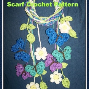 May include: A crochet scarf pattern featuring a circle of white, green, and purple yarn with a series of crocheted butterflies and flowers hanging from it. The text "Spring Butterfly Kisses Scarf Crochet Pattern" is at the top of the image and "Designs by Sharon Santorum" is at the bottom.
