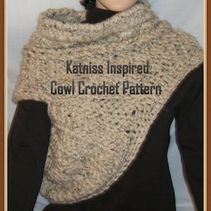 May include: A beige crochet cowl with a brown trim. The cowl is worn by a person and has a text overlay that reads "Katniss Inspired Cowl Crochet Pattern".