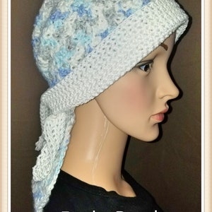 May include: A white crocheted bandana with blue and gray accents. The bandana is tied around a mannequin's head and the text "Funky Bandana" is printed below the mannequin's neck.