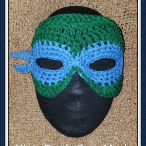 May include: Green and blue crocheted Ninja Turtle face mask.