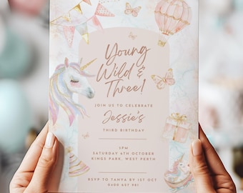 May include: A pastel-colored birthday invitation with the text "Young Wild & Three!" features a unicorn, hot air balloon, butterflies, and gift box illustrations. The invitation includes event details and RSVP information.
