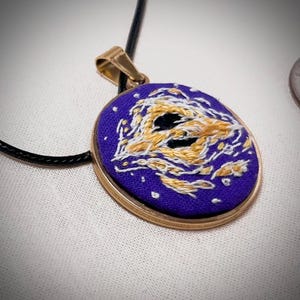 May include: A white ceramic mug with a black handle and the text "But First, Coffee" in a bold, black font. The mug is set against a blurred background, suggesting a cozy setting.