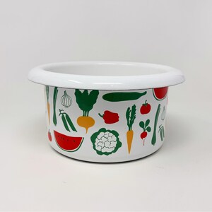 May include: White enamelware bowl with a rim, decorated with colorful illustrations of vegetables. The vegetables include carrots, tomatoes, watermelon, and cauliflower. The bowl is a kitchenware item.