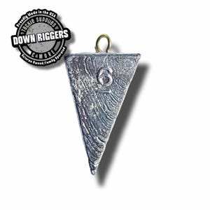 May include: A silver triangle-shaped fishing weight with a gold eyelet. The weight is marked with the number "6".