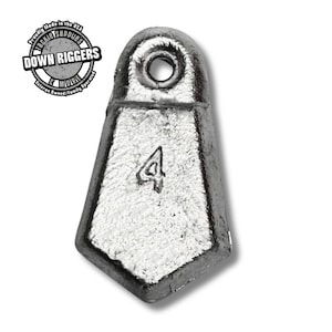 May include: A silver-colored fishing weight with a trapezoidal shape and a hole at the top. The number "4" is embossed on the front. The text "DOWN RIGGERS" and "Tackle Supplies" are visible.