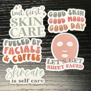 May include: Set of six colorful stickers with various skincare-related phrases, including "but first skin care", "fueled by facials & coffee", "good skin good mood good day", "let's get sheet faced", and "skincare is self care".