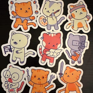 May include: A collection of colorful cat stickers. Each sticker features a cartoon cat in various professions, including a juggler, artist, athlete, accountant, architect, scholar, and more. The cats are orange, gray, and red with white accents.