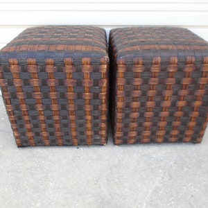 May include: Two brown wicker storage ottomans with a woven pattern.
