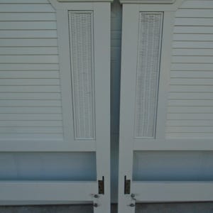 May include: Two off-white headboards with a woven panel and slatted design. Each headboard has a curved top with molding. The headboards are connected with metal hardware and are suitable for a bed frame.