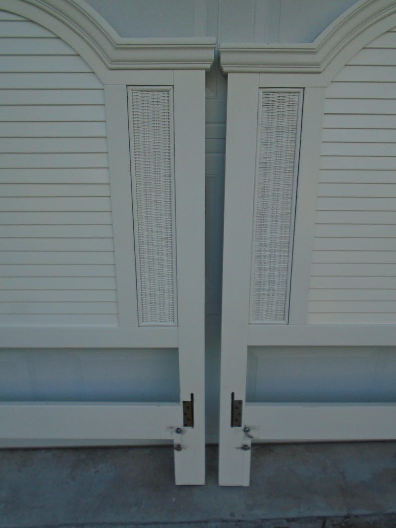 May include: Two off-white headboards with a woven panel and slatted design. Each headboard has a curved top with molding. The headboards are connected with metal hardware and are suitable for a bed frame.
