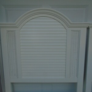 May include: White headboard with an arched top and horizontal slats. The headboard has woven wicker-style accents on the sides. The headboard is painted white and has a classic design.