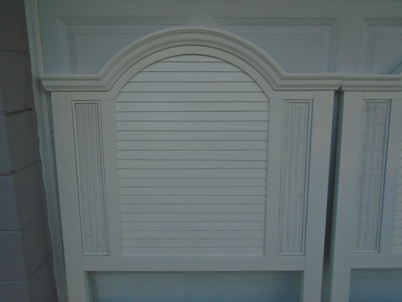 May include: White headboard with an arched top and horizontal slats. The headboard has woven wicker-style accents on the sides. The headboard is painted white and has a classic design.