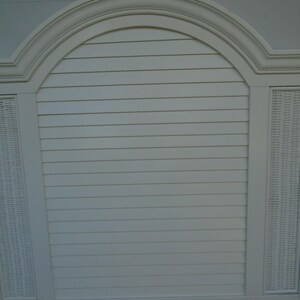 May include: A white headboard with a curved top and a slatted center section. The headboard has woven panels on either side and a decorative trim. The design is reminiscent of a coastal or tropical style.