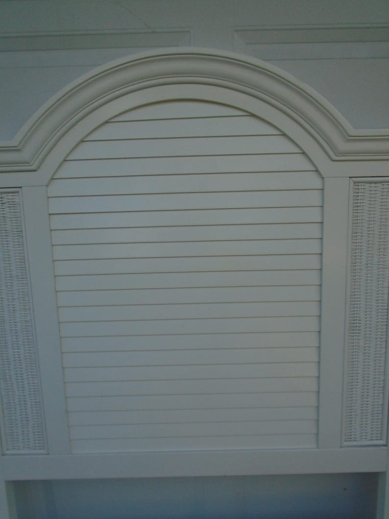 May include: A white headboard with a curved top and a slatted center section. The headboard has woven panels on either side and a decorative trim. The design is reminiscent of a coastal or tropical style.