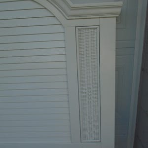 May include: A white headboard with a curved top and a rectangular woven panel. The headboard has horizontal slats and a decorative frame. The overall design is clean and coastal.