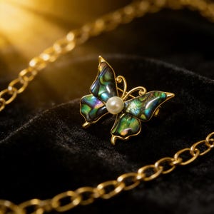 May include: A butterfly brooch with iridescent wings in shades of green, blue, and purple, centered with a pearl. The gold-toned frame and chain add a touch of elegance. The brooch is set against a black velvet background.