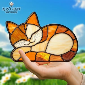 May include: Stained glass cat figurine in shades of orange, cream, and brown. The cat is in a relaxed pose with its eyes closed. The AGV CRAFT logo is in the upper left corner, with the text "Never Ending Craft" below it.