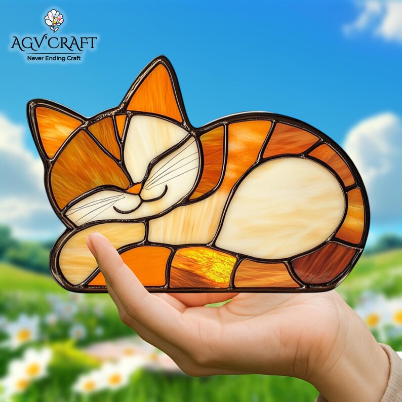 May include: Stained glass cat figurine in shades of orange, cream, and brown. The cat is in a relaxed pose with its eyes closed. The AGV CRAFT logo is in the upper left corner, with the text "Never Ending Craft" below it.