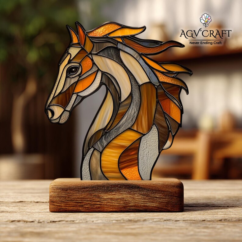 Peut inclure: Une sculpture de t&ecirc;te de cheval en vitrail aux tons marron, orange et gris, mont&eacute;e sur une base en bois rectangulaire. La sculpture pr&eacute;sente un design d&eacute;taill&eacute; avec diverses formes et textures. Le logo "AGV Craft" est visible.